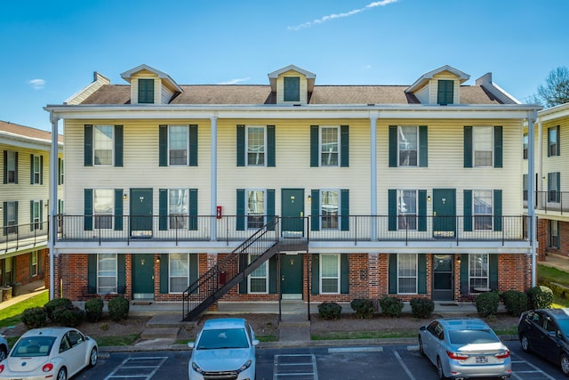 view of building exterior featuring uncovered parking