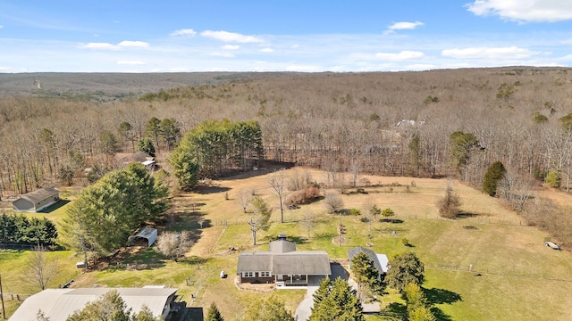 birds eye view of property featuring a wooded view