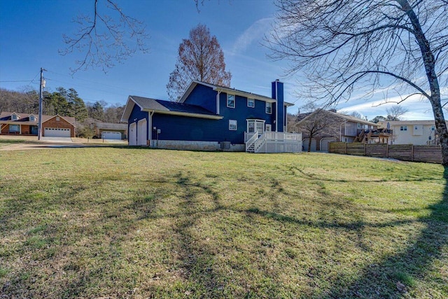 back of property with a lawn and a garage