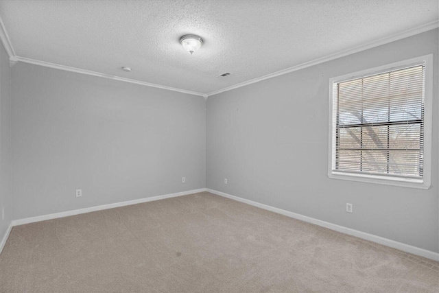 spare room with a textured ceiling, crown molding, and light colored carpet