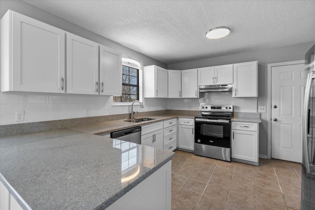 kitchen with backsplash, stainless steel appliances, white cabinets, light tile patterned floors, and sink