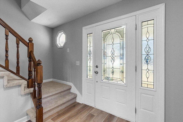 foyer entrance with light hardwood / wood-style floors