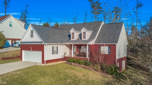 view of front of property with a garage, concrete driveway, a front yard, a porch, and brick siding