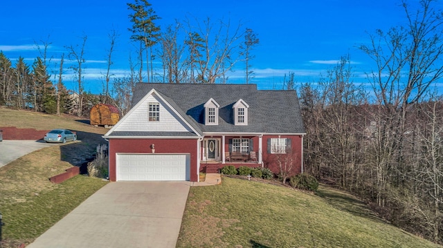 view of front of house featuring a shingled roof, concrete driveway, covered porch, a front yard, and brick siding