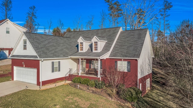 cape cod-style house with concrete driveway, roof with shingles, covered porch, a front lawn, and brick siding