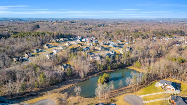 birds eye view of property with a water view and a view of trees