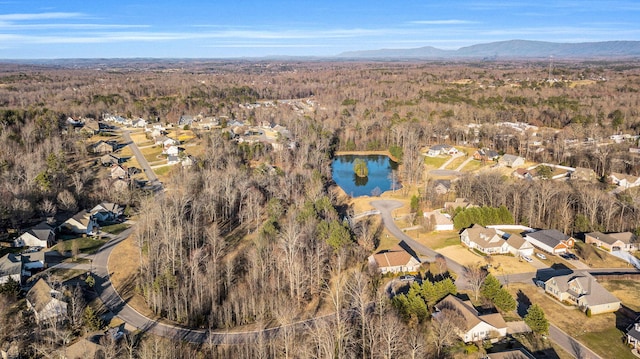 bird's eye view with a residential view, a wooded view, and a water and mountain view