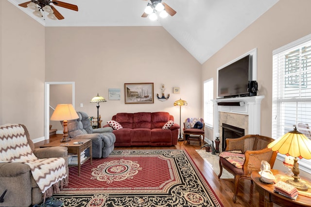 living area featuring ceiling fan, high vaulted ceiling, and wood finished floors