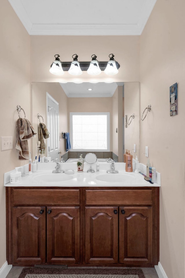 bathroom with crown molding, a sink, and double vanity