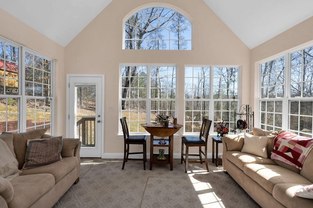 sunroom / solarium with a healthy amount of sunlight and vaulted ceiling