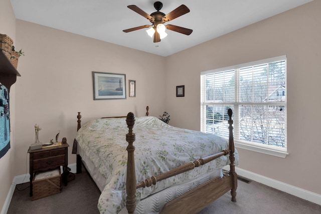 carpeted bedroom with multiple windows, ceiling fan, and baseboards