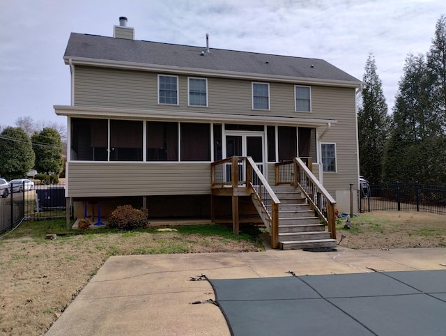 rear view of house with a patio area and a sunroom