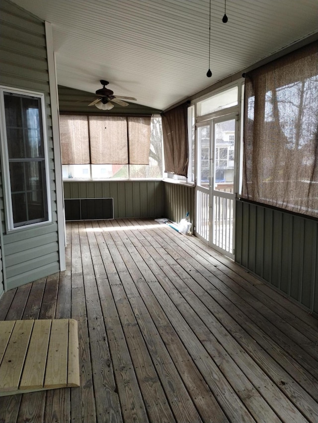 unfurnished sunroom with a ceiling fan