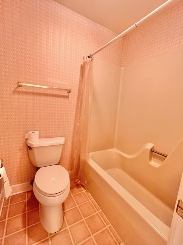 bathroom with tile patterned floors, shower / tub combo, toilet, and wallpapered walls