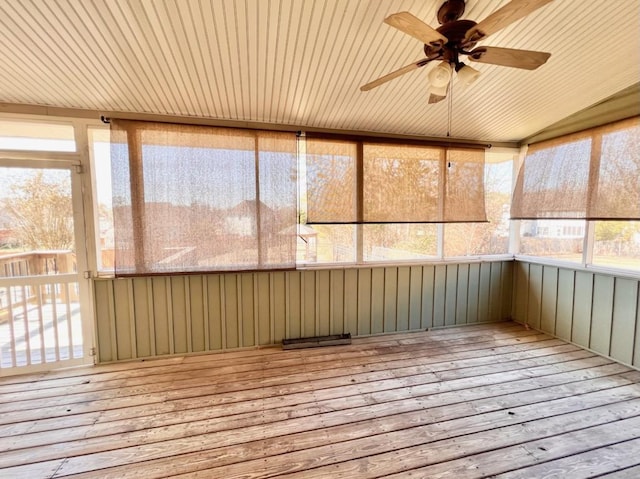 unfurnished sunroom featuring a ceiling fan