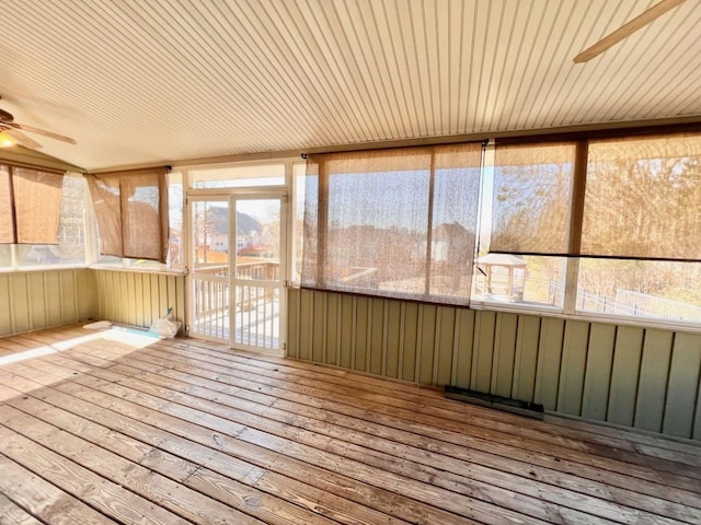 unfurnished sunroom with a ceiling fan