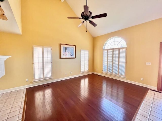 unfurnished living room with a ceiling fan, light wood-type flooring, a fireplace, and baseboards