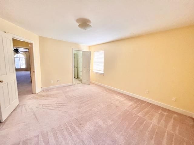 unfurnished bedroom with carpet, baseboards, and a closet