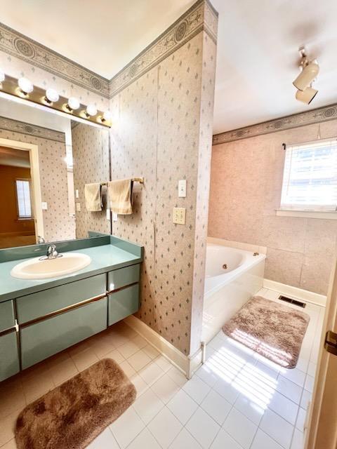 full bath featuring a wealth of natural light, tile patterned floors, and wallpapered walls