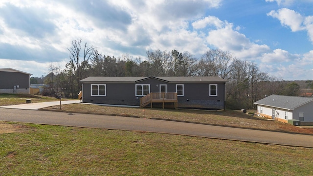 view of front of home with central AC and a front yard