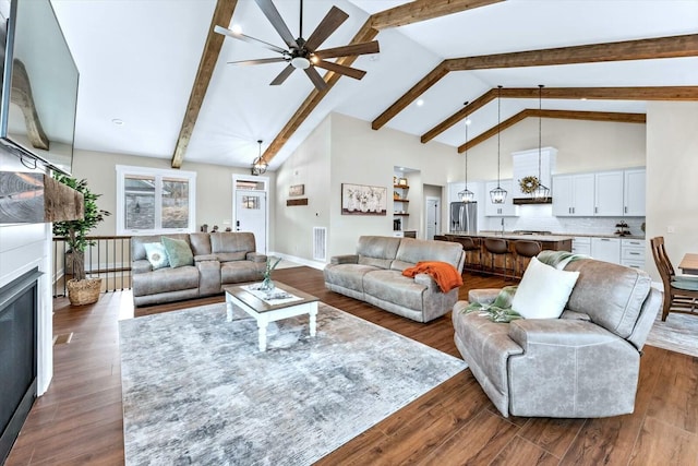 living room with ceiling fan, high vaulted ceiling, dark hardwood / wood-style flooring, and beamed ceiling