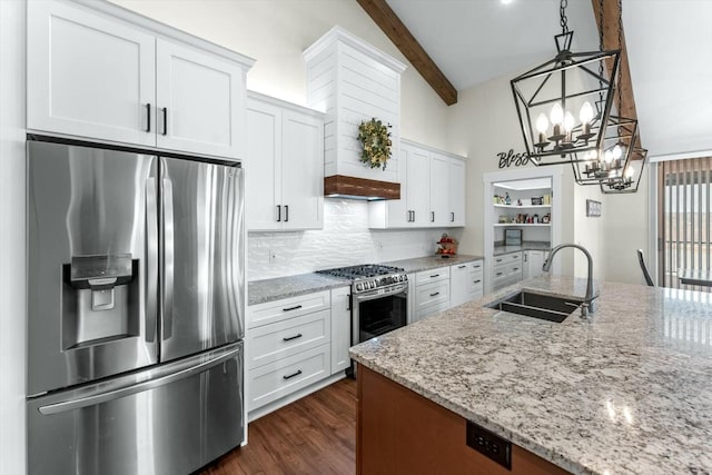 kitchen featuring decorative light fixtures, light stone countertops, sink, appliances with stainless steel finishes, and white cabinets