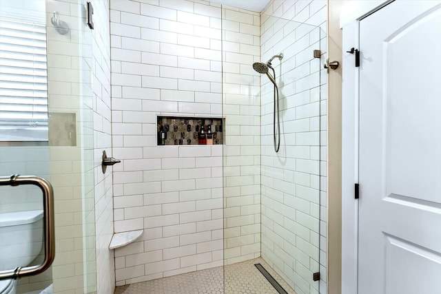 bathroom with toilet and walk in shower