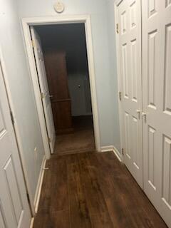 hallway with dark hardwood / wood-style floors