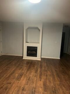 unfurnished living room featuring dark hardwood / wood-style flooring