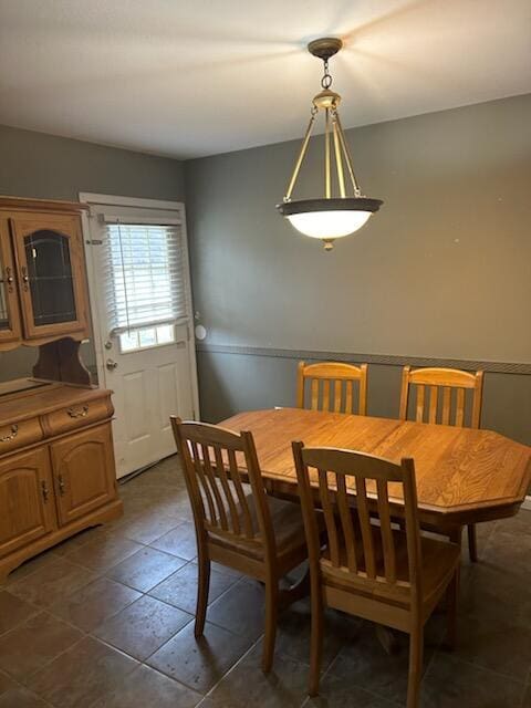 dining room featuring dark tile patterned floors