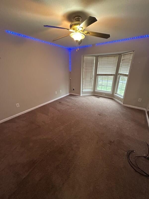 unfurnished room with carpet and ceiling fan