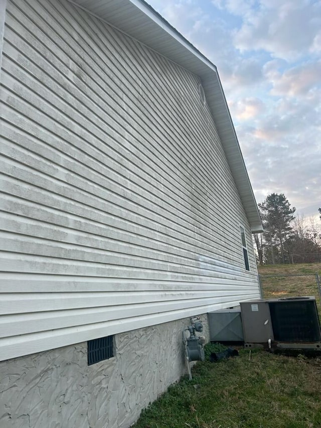 view of side of property with central AC unit