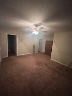 interior space featuring ceiling fan and dark colored carpet