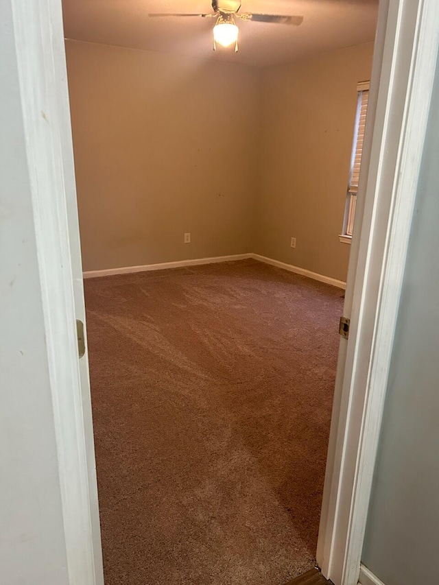 empty room with carpet floors and ceiling fan