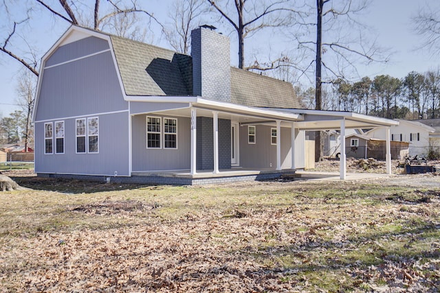 back of house featuring a porch