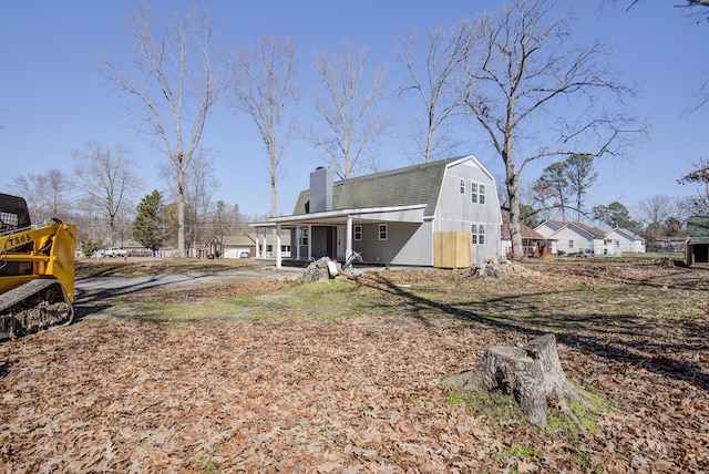 back of property featuring covered porch