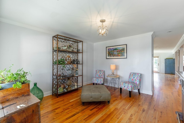 living area featuring baseboards, crown molding, an inviting chandelier, and wood finished floors