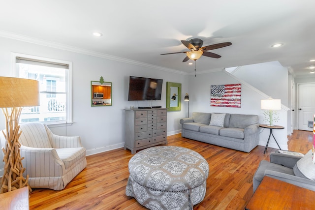 living area featuring crown molding and light wood-style floors