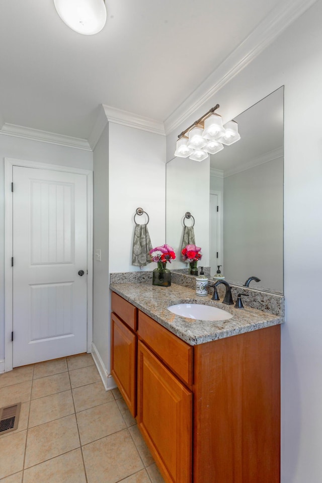 bathroom with visible vents, ornamental molding, tile patterned flooring, baseboards, and vanity