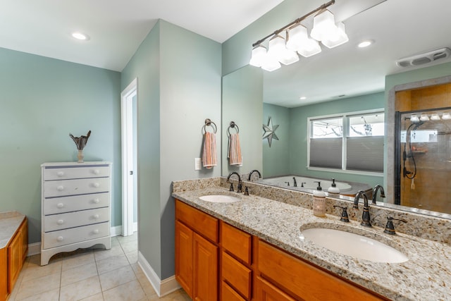 full bathroom featuring tile patterned floors, tiled shower, visible vents, and a sink