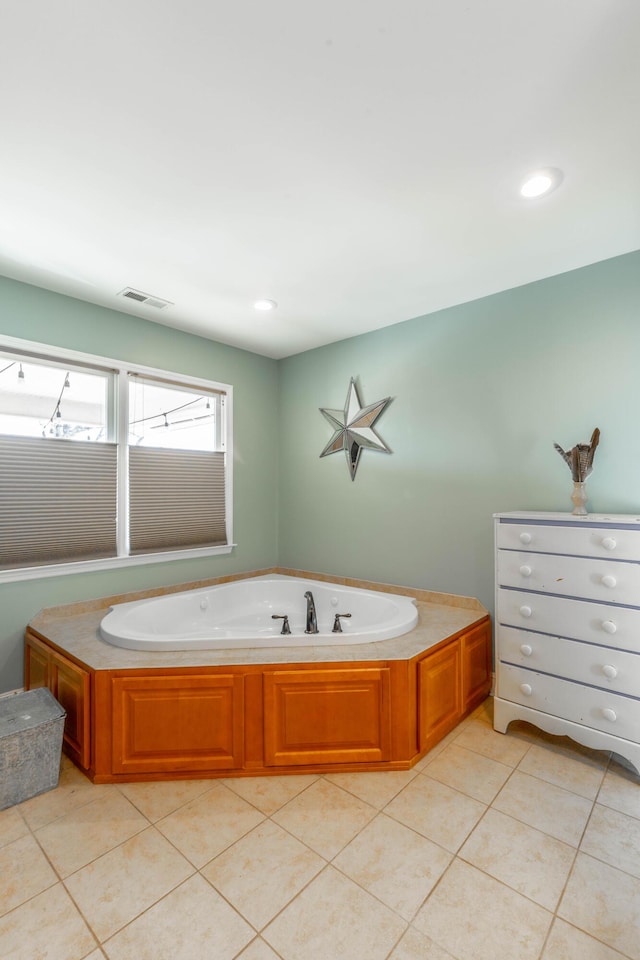 bathroom with tile patterned flooring, visible vents, recessed lighting, and a garden tub