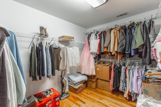 walk in closet featuring wood finished floors and visible vents