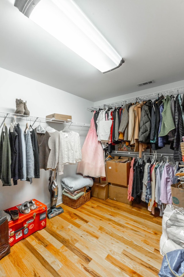 walk in closet featuring visible vents and wood finished floors