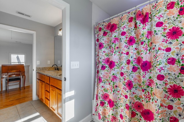 bathroom with visible vents, curtained shower, vanity, and tile patterned flooring