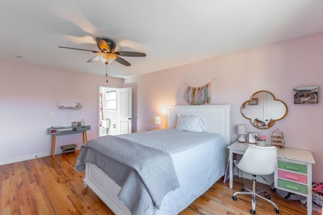 bedroom with light wood finished floors, baseboards, and a ceiling fan