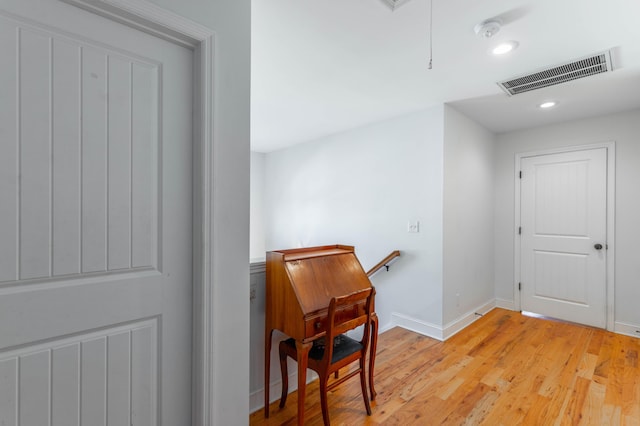 hall with visible vents, baseboards, attic access, recessed lighting, and light wood-style flooring