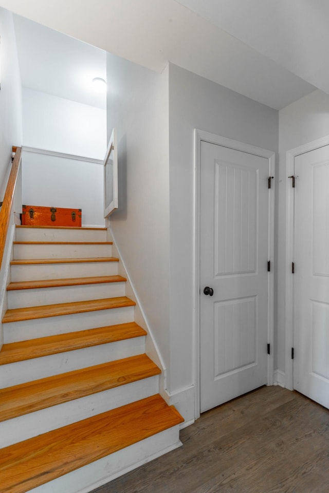 stairs featuring baseboards and wood finished floors