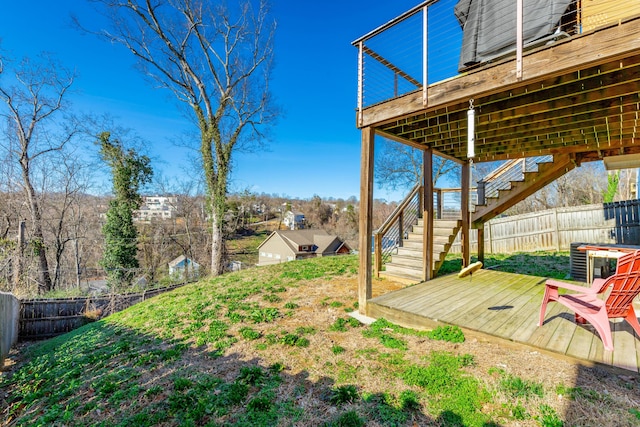 view of yard with stairway, a wooden deck, and a fenced backyard