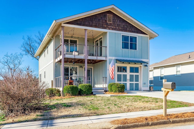 view of front of house featuring a balcony, covered porch, and board and batten siding