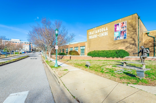 view of road featuring sidewalks, curbs, and street lights